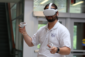 Graduate student Mike Cho uses an Oculus Quest 2 in the Gentry building atrium (July 2021)